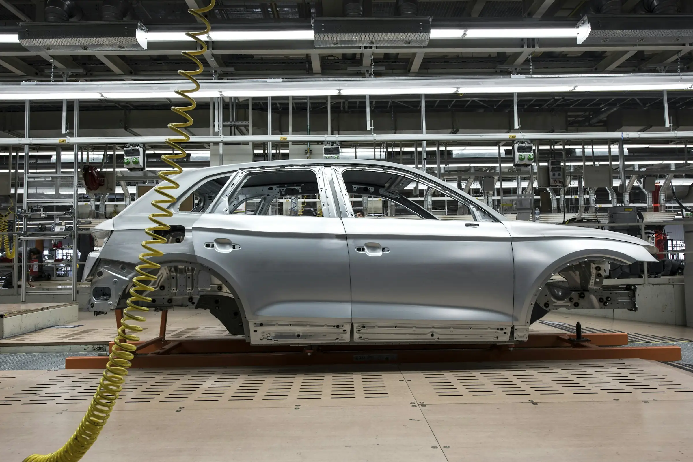 Unpainted car body shell on an automotive assembly line
