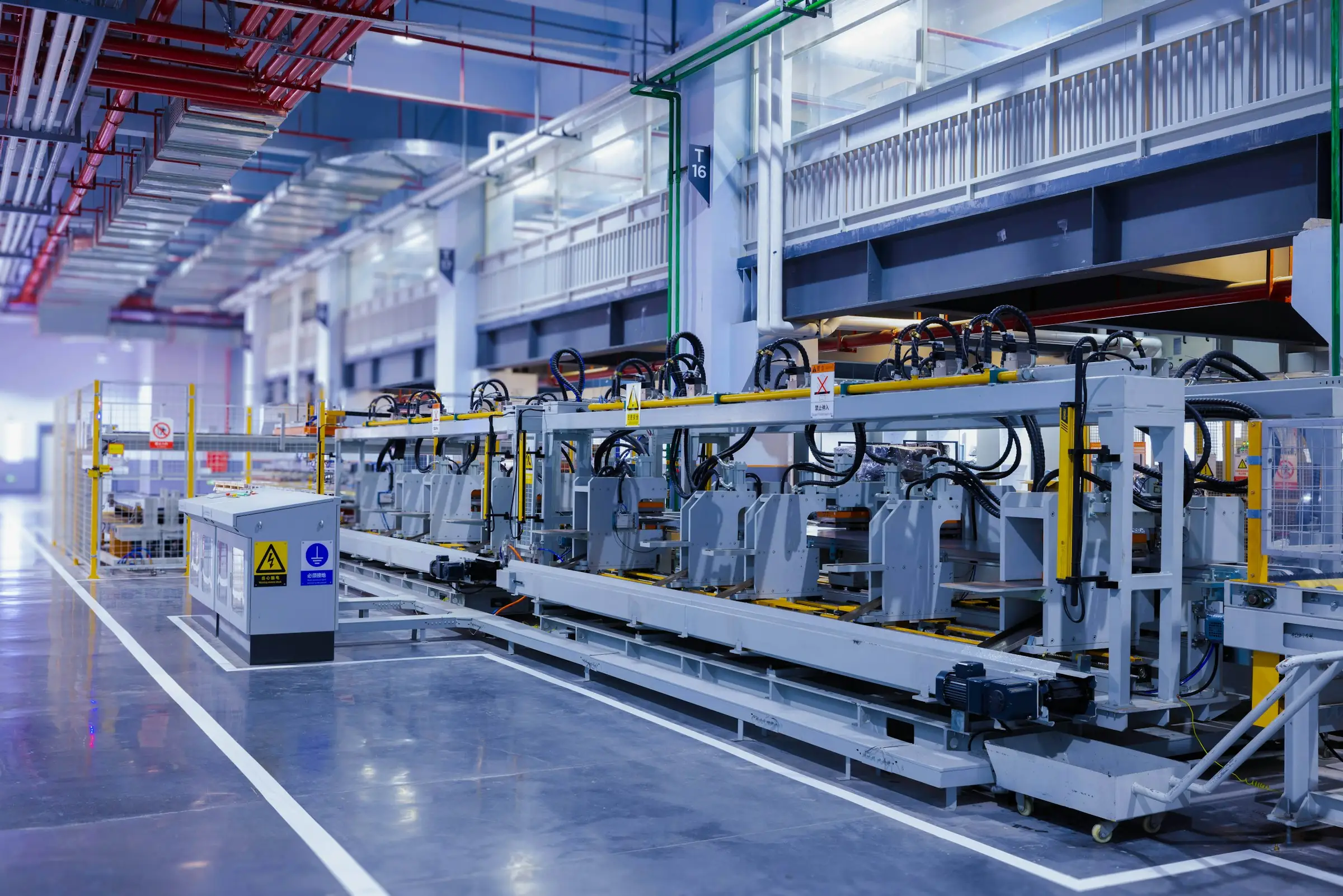 Large production machinery line inside a modern factory hall